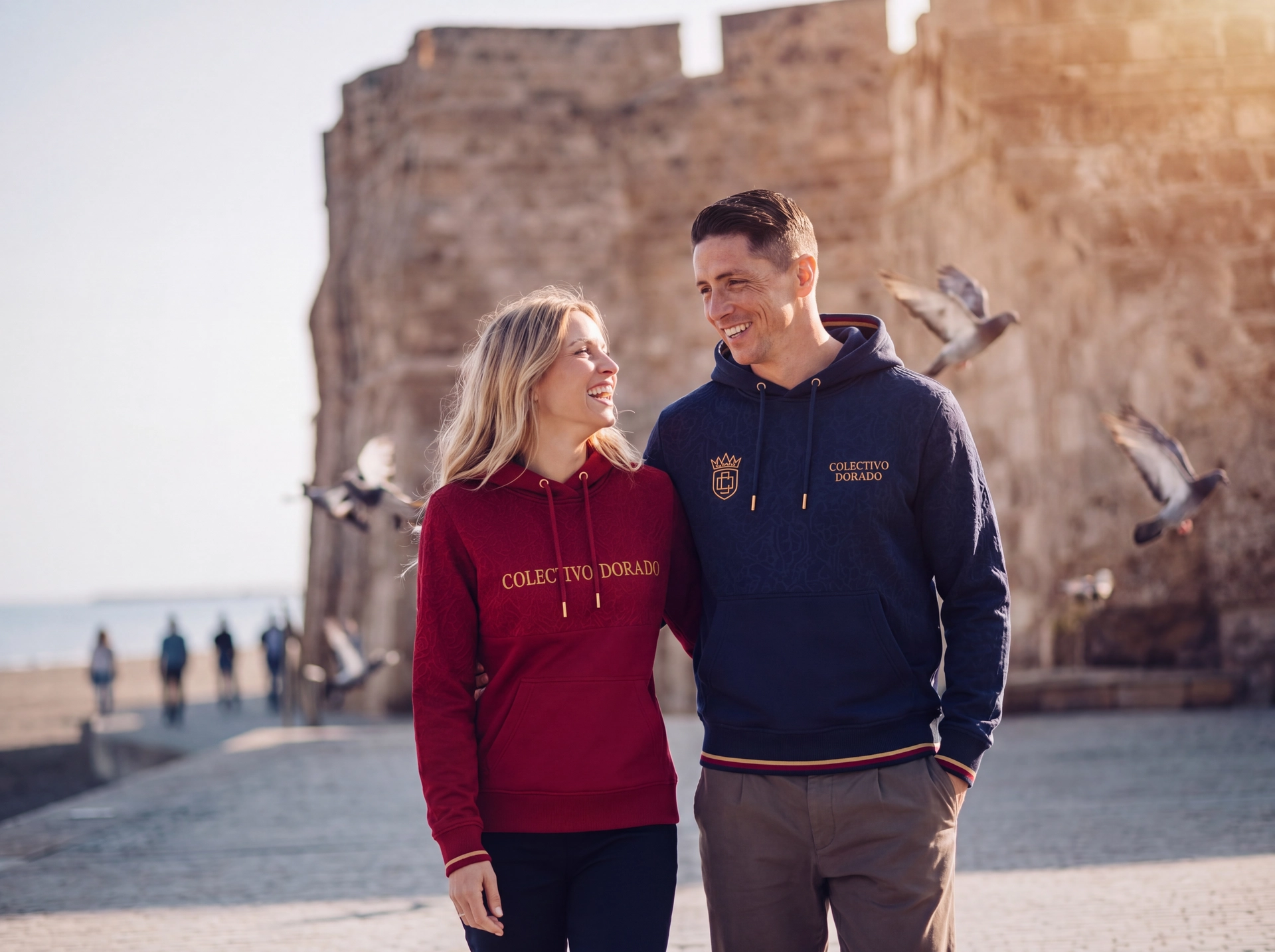 Fernando Torres and partner in Colectivo Dorado apparel in a Spanish coastal setting
